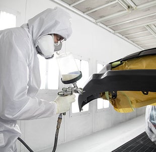 Collision Center Technician Painting a Vehicle | Billion Toyota of Clinton in Clinton IA